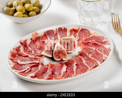 Jamon on a plate with figs Stock Photo