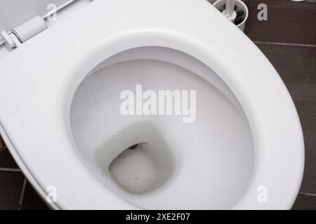 White toilet bowl in the toilet in the bathroom. Stock Photo