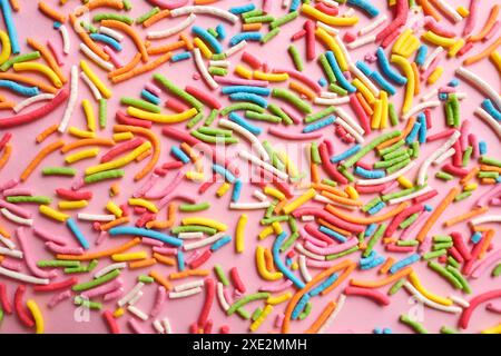 Multi-colored confectionery topping on a pink. Stock Photo