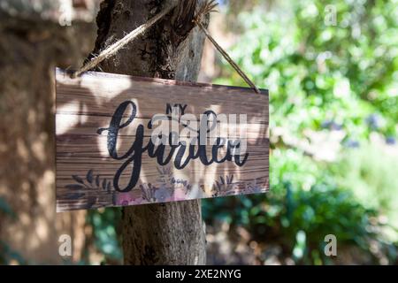 Garden sign with mediterranean courtyard as background. English language letters Stock Photo