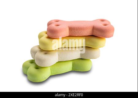 Stack of colorful bone shaped dog biscuit isolated on white background. Stock Photo