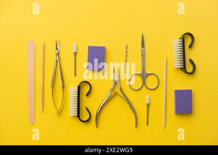 Professional manicure tools on yellow background. Manicure set. Stock Photo