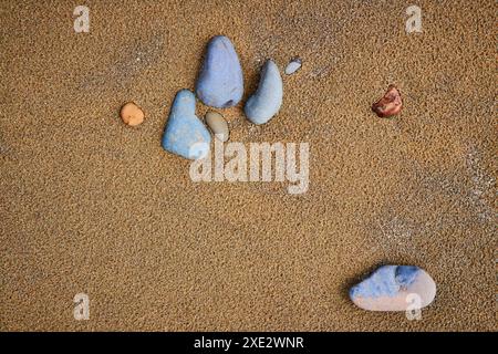 Serene Stones on Sandy Beach Close-Up Stock Photo