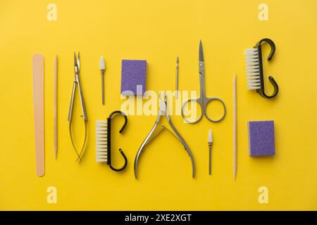 Professional manicure tools on yellow background. Manicure set. Stock Photo