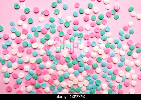 Multi-colored confectionery topping on a pink. Stock Photo