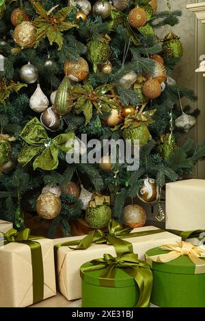 Close up gift boxes under green Christmas tree Stock Photo