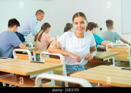 Portrait of smiling girl student looking at camera during lesson Stock Photo