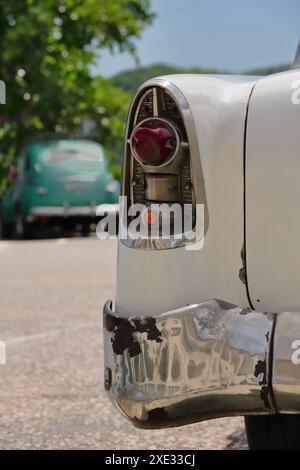 440 Rear detail, white-red American classic car -Chevrolet from 1956- at the National Shrine Basilica Our Lady of Charity rear parking. Santiago-Cuba. Stock Photo