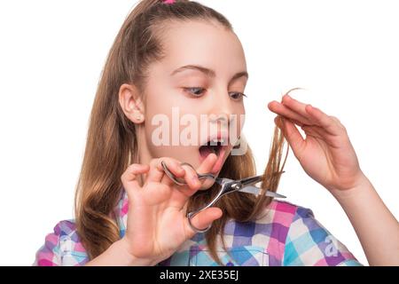 Teen girl amazed hairdresser in hair salon. Hairstylist working in a hair salon. Hairdresser teen girl using scissors isolated on white. Haircut at Stock Photo