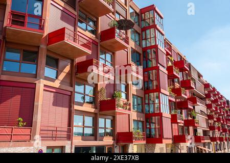 Red apartment building with balconies seen in Berlin, Germany Stock ...