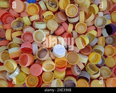Phang Nga, Thailand - February 21, 2024: Plastic сollecting for recycling. Plastic caps and lids from water bottles for reuse and reduce concept. Stock Photo