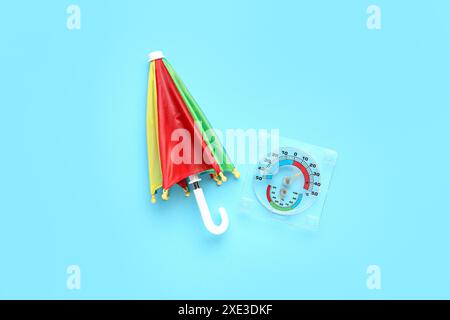 Mini colorful umbrella on blue background Stock Photo