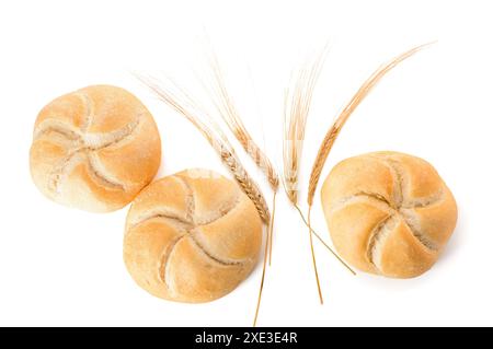 Delicious kaiser rolls and wheat ears on white background Stock Photo