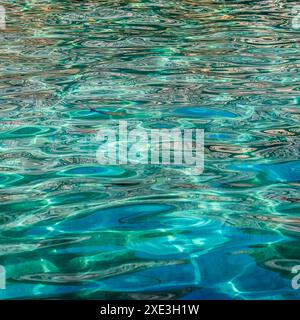 Emerald sea in sunshine glow as surface background. Summer holidays concept Stock Photo