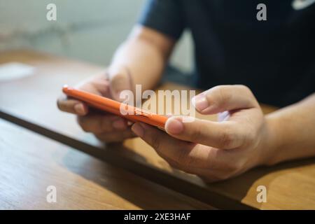 Man playing game on mobile phone. gamer boy playing video games holding SmartphoneÂ working mobile devices. cell telephone techn Stock Photo