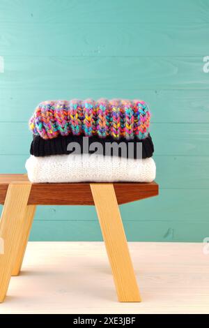 Stack of women's clothing. Warm female woollen knitted sweaters. winter and autumn fashion compositi Stock Photo