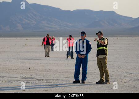 In this file photo, NASA astronaut Butch Wilmore, and Boeing Starliner Launch Conductor Louis Atchison, right, watch as Boeing and NASA teams work around Boeing's CST-100 Starliner spacecraft after it landed at White Sands Missile Range's Space Harbor, in New Mexico. Teams at NASA and Boeing are adjusting the return to Earth of the Starliner Crew Flight Test spacecraft with agency astronauts Butch Wilmore and Suni Williams from the International Space Station. The move off Wednesday, June 26, deconflicts Starliner's undocking and landing from a series of planned International Space Station spa Stock Photo