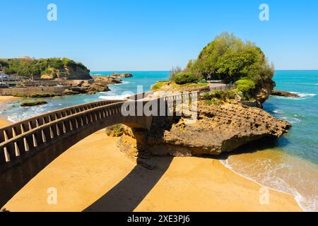 Stone bridge to the Rocher du Basta, the scenic rock and major landmark in the coast of Biarritz, France. Stock Photo