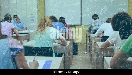 Image of chemical equations against rear view of diverse students studying in class at college Stock Photo