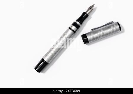 Modern Fountain pen on blank white paper with Copy space Stock Photo