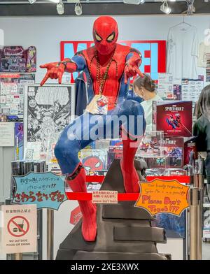 Kita Ward, Osaka, Japan. Dec 24, 2023. A human size model Spider Man from a comic cartoon character figure at HEP FIVE mall. Stock Photo