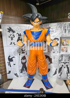 Kita Ward, Osaka, Japan. Dec 24, 2023. A human size model Goku from Dragon Ball comic cartoon character figure at a Jump Shop at Stock Photo