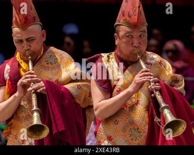 Ladakhi monks playing musical instrument wearing traditional costume during Hemis festival at Leh, India on 17 June 2024 Stock Photo