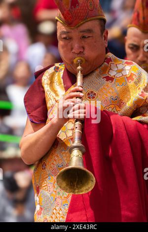 A Ladakhi monk playing a musical instrument wearing traditional costume during Hemis festival at Leh, India on 17 June 2024 Stock Photo