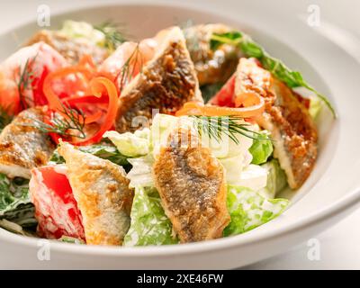 Delicious salad with fried baked smelt fish Stock Photo