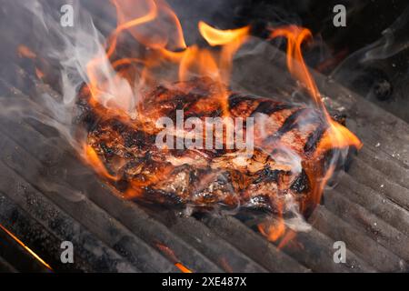 Searing and smoking ribeye steaks on grill Stock Photo