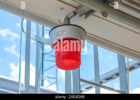 Calgary, Alberta, Canada. Jul 10, 2023. A red led warning light emergency strobe light signal flashing lamp at a gas plant. Stock Photo