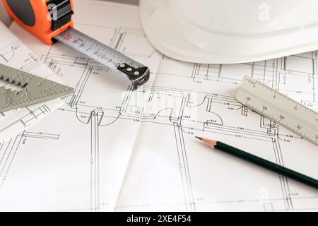 Architecture plans and contractor supplies on desk Close up. Copy space Stock Photo