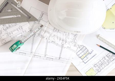 Architecture plans and contractor supplies on desk. Top view Stock Photo