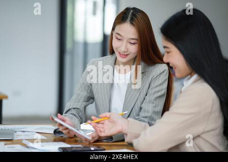 Working women are discussing work and planning new business plans exchanging ideas with colleagues Stock Photo