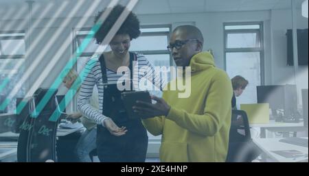 Image of graphs, globe and computer language over diverse coworkers discussing over tablet Stock Photo
