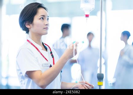 Nurse preparing an intravenous drip Stock Photo