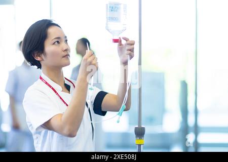 Nurse preparing an intravenous drip Stock Photo