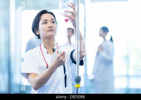 Nurse preparing an intravenous drip Stock Photo