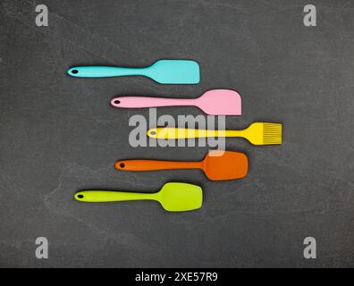 Silicone culinary spatulas and brushes on black Stock Photo