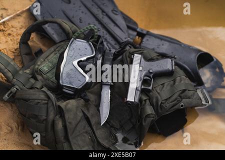 Tactical equipment of a reconnaissance combat swimmer, tactical vest, fins, diving mask, pistol and knife. Stock Photo