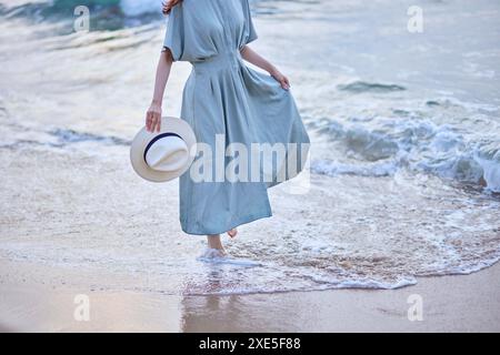 Young Japanese woman enjoying a vacation on the seaside Stock Photo