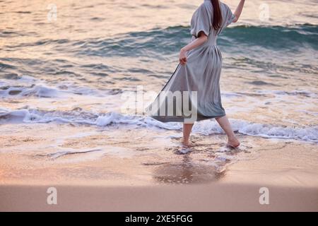 Young Japanese woman enjoying a vacation on the seaside Stock Photo