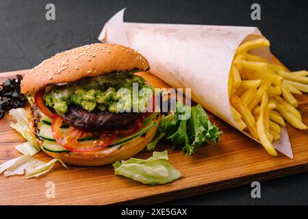 Burger with french fries on wooden tray Stock Photo