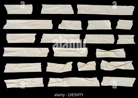 Assorted strips and pieces of masking adhesive tape isolated on a black background. Sticky scotch, duct paper. Design elements. Stock Photo