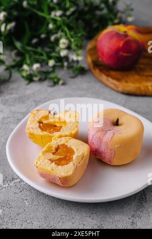 Two small french mousse cake apple shaped dome served on a plate Stock Photo