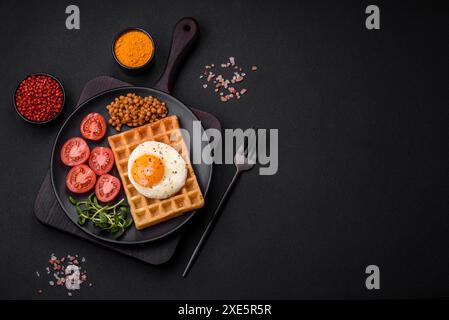 Delicious hearty breakfast consisting of a fried egg, Belgian waffle Stock Photo