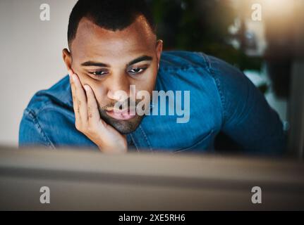 Businessman, bored and tired with computer in workplace, problem solving and solution with decision at night. Working late, web designer and monitor Stock Photo