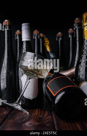 Different bottles of champagne with a glass of white champagne Stock Photo