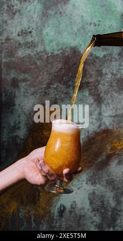 Pouring fresh beer into glass Stock Photo