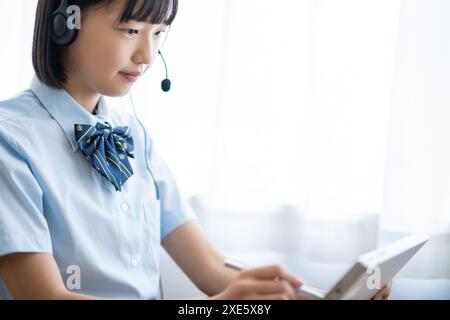 Student taking a class using a tablet Stock Photo